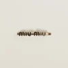 Black Enameled Metal Hair Clip | Miu Miu