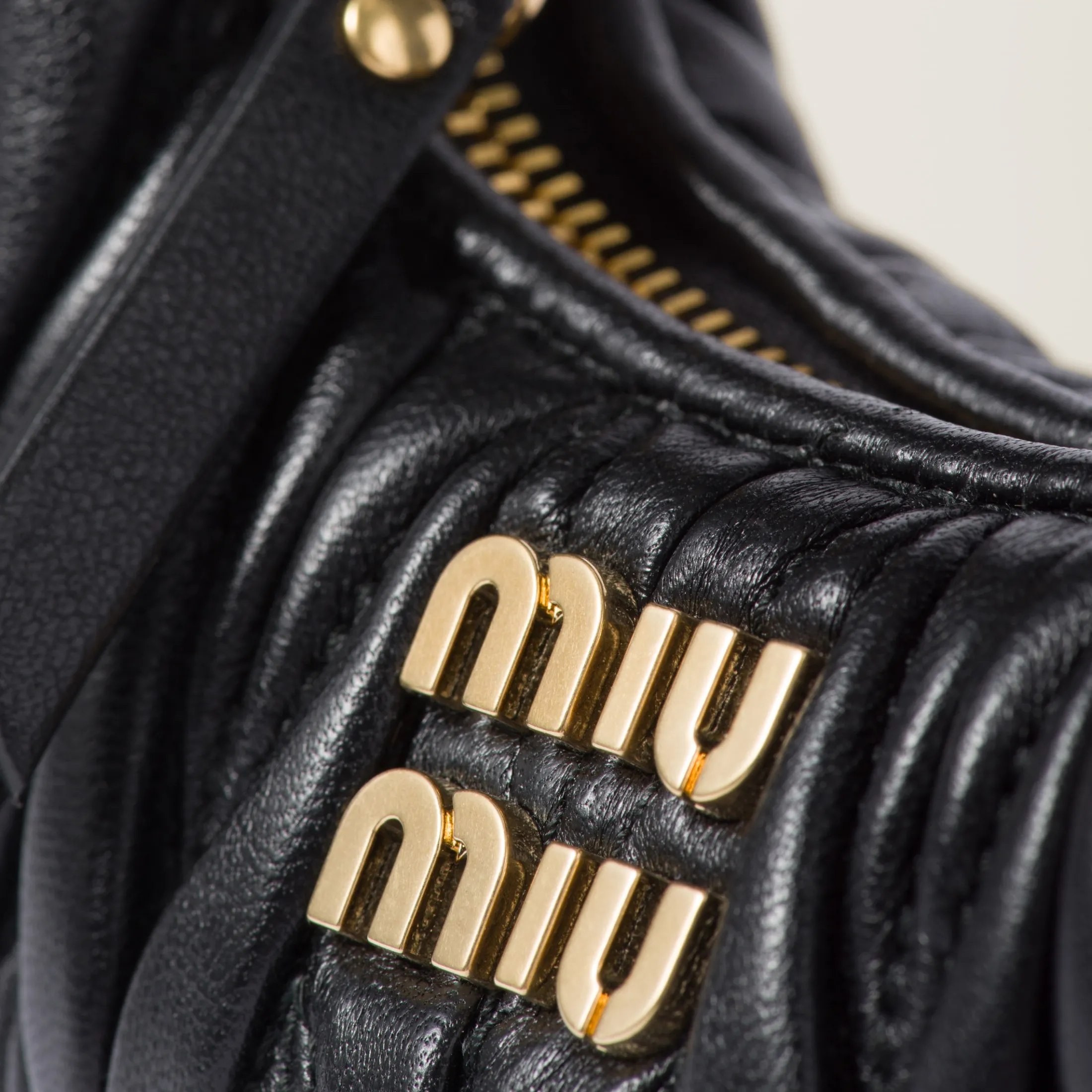 Black Wander Matelassé Nappa Leather Micro Hobo Bag | Miu Miu